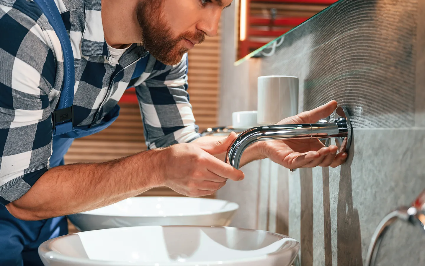 man repairing sink